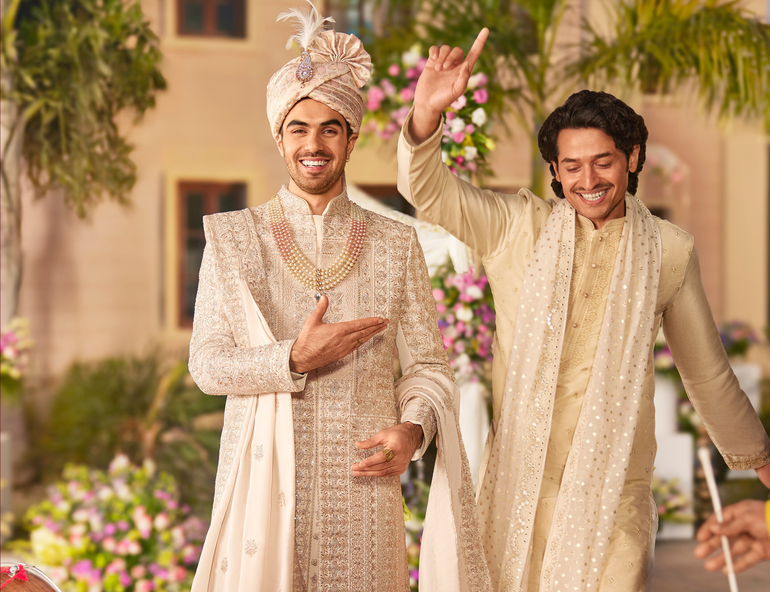 Groom dancing and enjyoing wearing elegant embroided kurta pajama with safa and dupatta